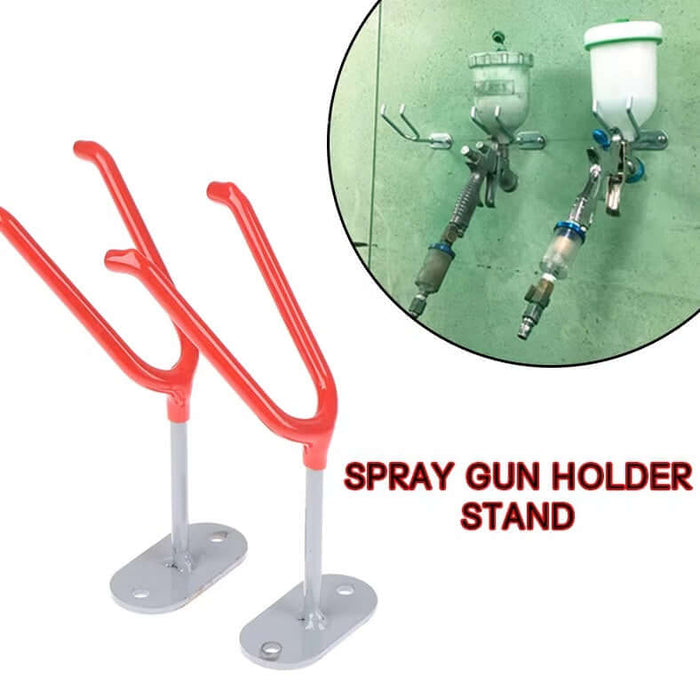 Wall-mounted spray gun holder stand with rubber protection for organized workspace.