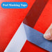 Blue painters tape being peeled from red surface, demonstrating clean removal with no residue.