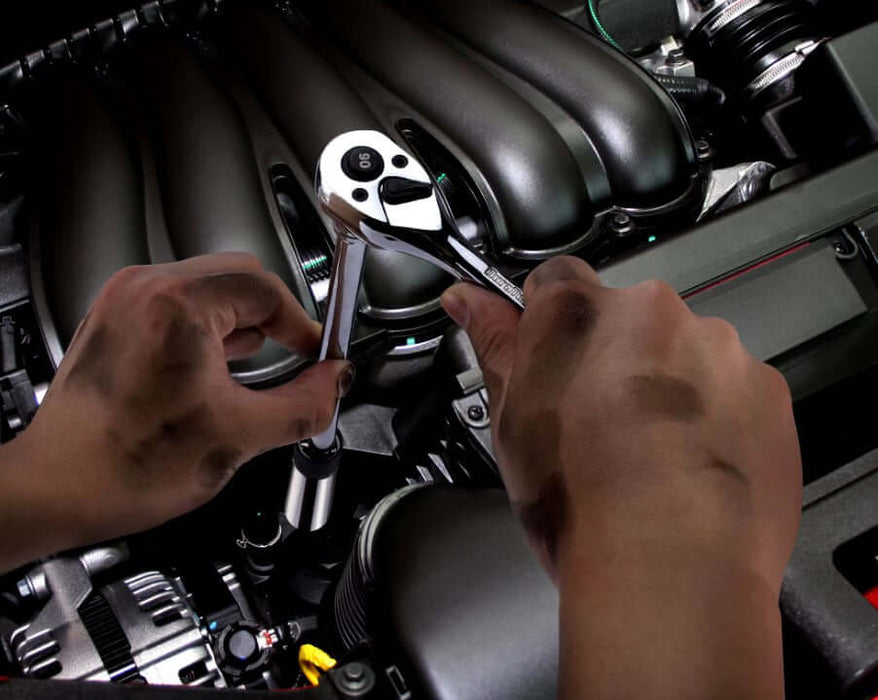 Mechanic using DURATECH 3-piece Magnetic Swivel Spark Plug Socket Set on car engine for efficient maintenance.