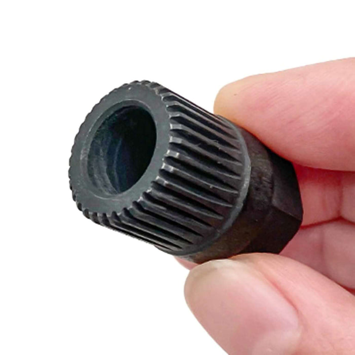 Hand holding a black alternator clutch wheel pulley removal tool with 33 splines and T50 TORX compatibility.