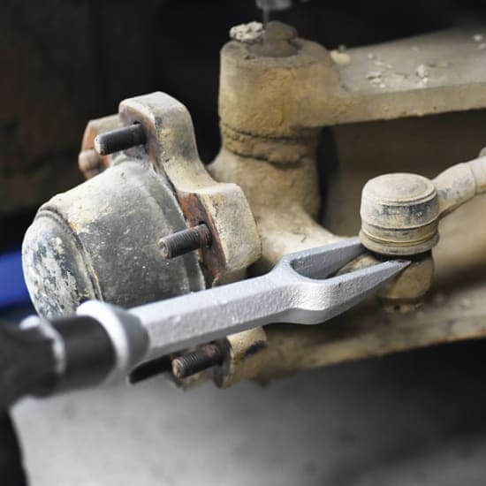 Toledo Ball Joint Separator being used on a vehicle suspension component for effective ball joint removal.