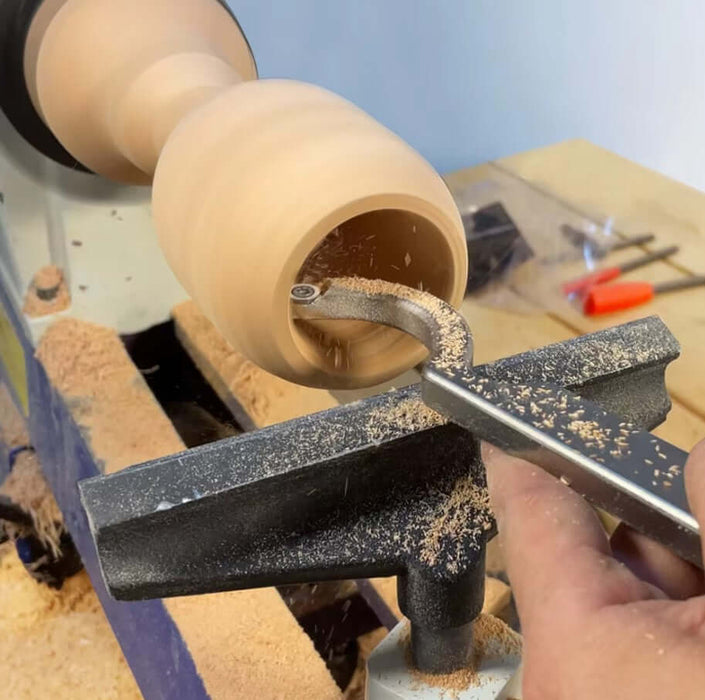 Using a Wood Turning Tool Chisel with Carbide Insert Cutter Set on a wooden piece in a workshop.