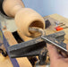 Using a Wood Turning Tool Chisel with Carbide Insert Cutter Set on a wooden piece in a workshop.